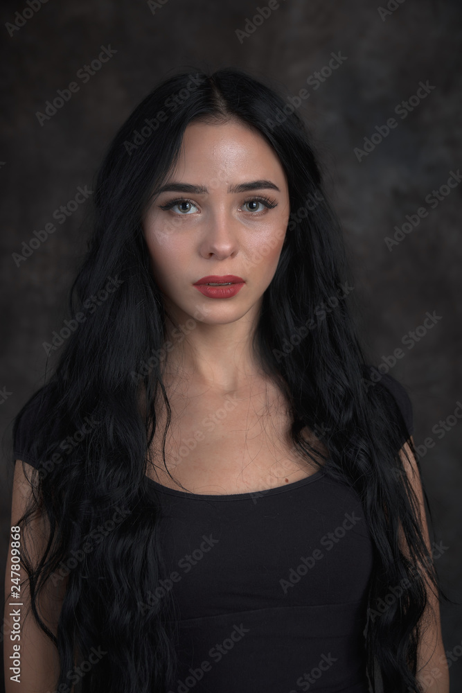 Young beautiful girl on a dark background Young beautiful girl on a dark background