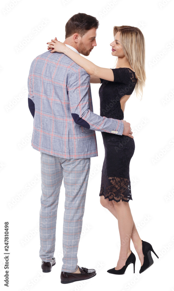Side view of a hugging couple in evening outfits. Side view of a hugging couple in evening outfits.