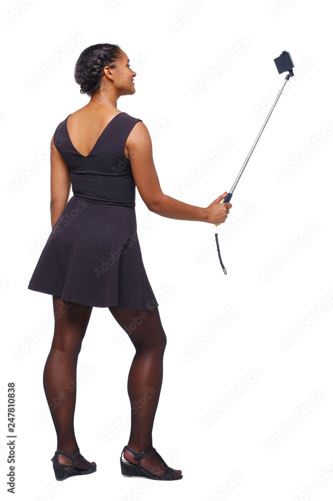 Back view of an African-American woman taking a selfie. Back view of an African-American woman taking a selfie.