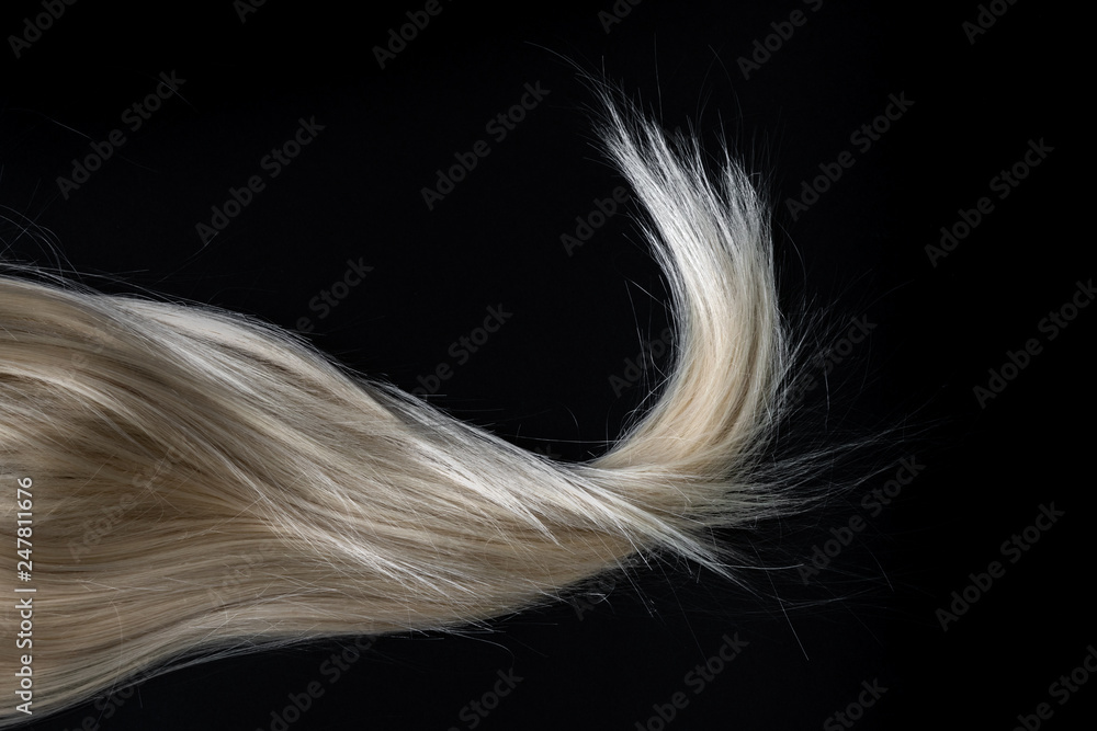 Blond shiny hair on black. Abstract fashion style background. Blond shiny hair on black. Abstract fashion style background.