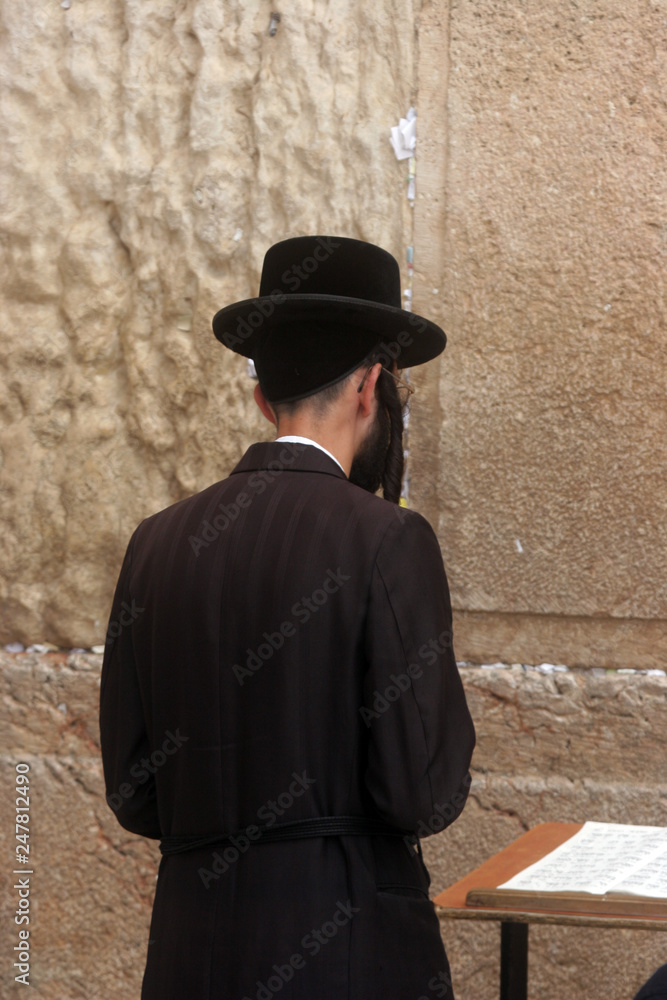 Jewish men pray at the western wall in Jerusalem, IL. 