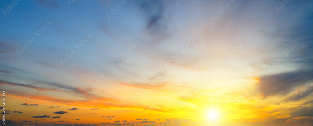 Cloudy sky and bright sunrise over the horizon. Wide photo.