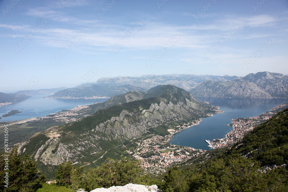 Panorama UNESCO World Heritage Site bay of Kotor with high mountains plunge into adriatic sea and Historic town of Kotor, Montenegro