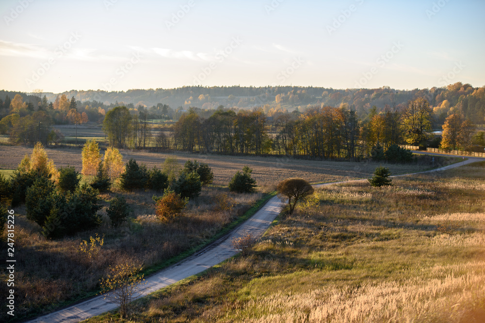 Obraz premium empty country gravel road with mud puddles and bumps