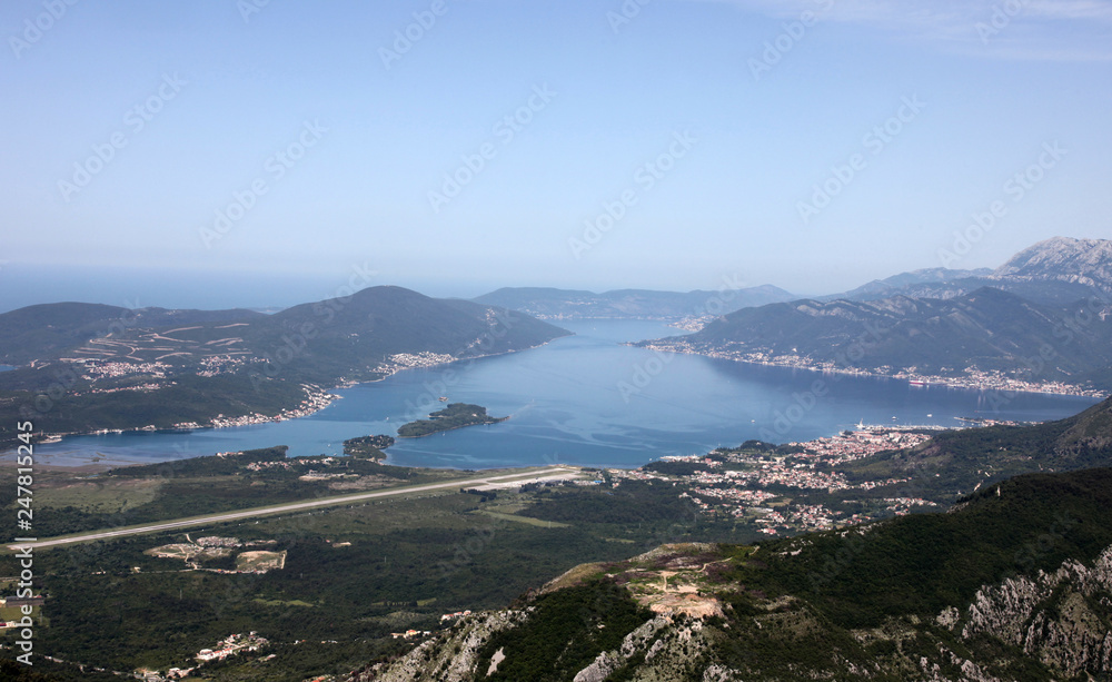 Panorama UNESCO World Heritage Site bay of Kotor with high mountains plunge into adriatic sea and town of Tivat, Montenegro
