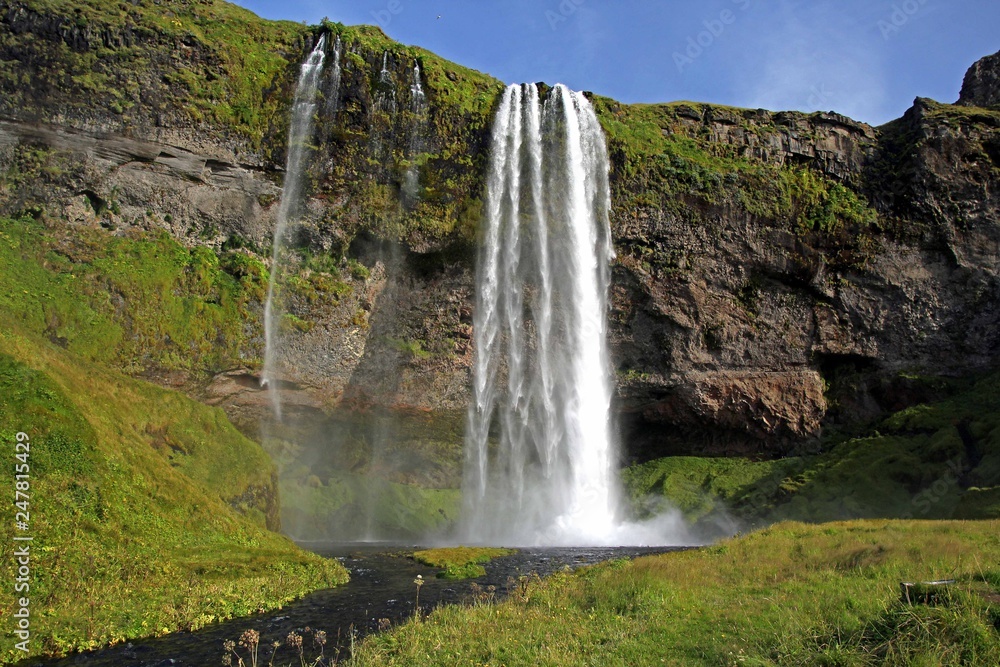 Spectacular flowing waterfalls in the countryside of Iceland