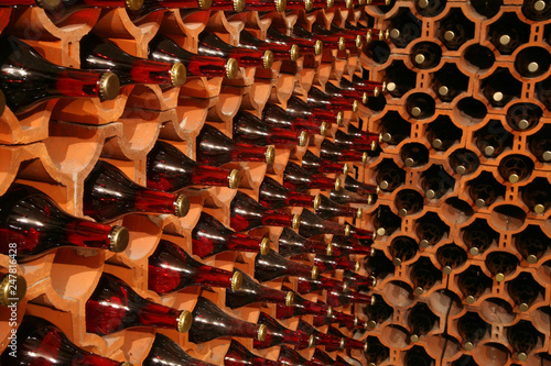Racks with bottles in a dark wine cellar