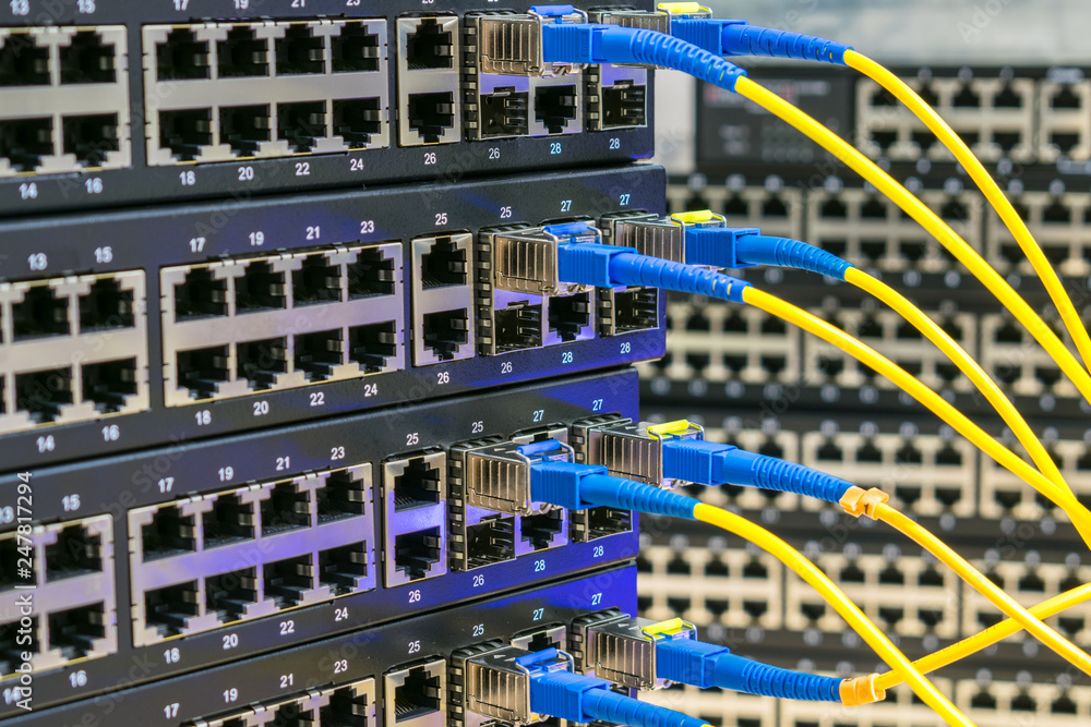 Server communication equipment of the Internet provider. Fiber-optic cables are connected to the switch ports. High-speed data transfer. Server communication equipment of the Internet provider. Fiber-optic cables are connected to the switch ports. High-speed data transfer.