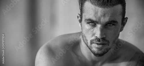 Portrait of a handsome caucasian male model posing on the beach