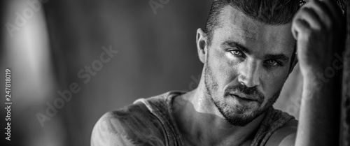 Portrait of a handsome caucasian male model posing on the beach
