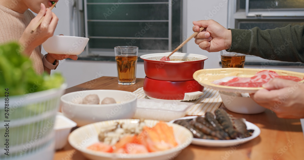 Couple eating hot pot at home Couple eating hot pot at home