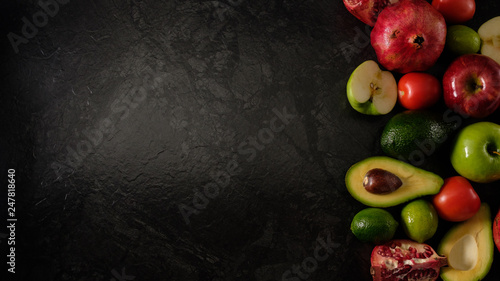 Fototapeta Naklejka Na Ścianę i Meble -  Healthy food. Vegetables and fruits. On a black background. Top view. Copy space..