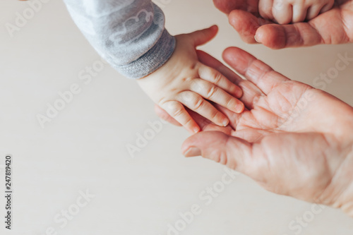 An old woman and a kid holding hands together