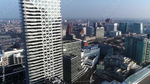 Aerial helicopter view moving past modern skyscraper located at downtown The Hague is city on the western coast of the Netherlands and the capital of the province of South Holland 4k high resolution photo