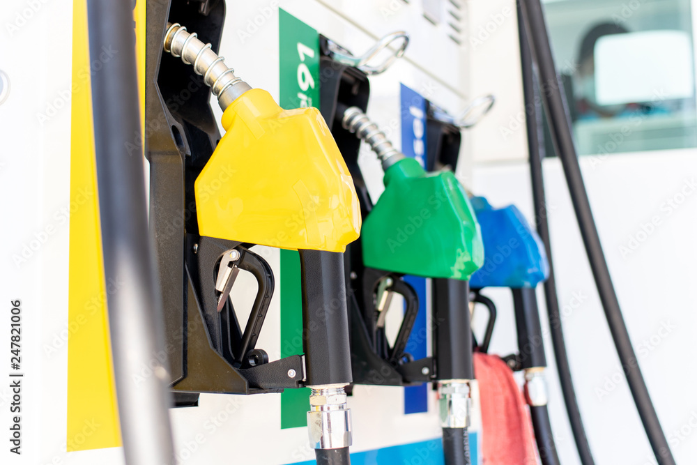 Fuel oil dispenser in petrol filling station. Fuel nozzle at a gas station. Fuel oil dispenser in petrol filling station. Fuel nozzle at a gas station.