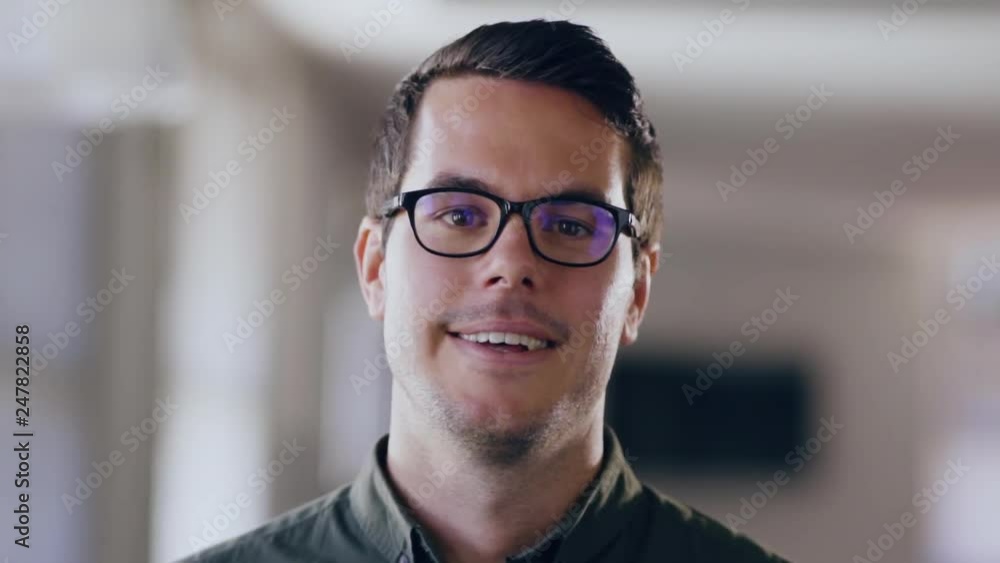Man smiling at camera . Proud male in a modern office Man smiling at camera . Proud male in a modern office