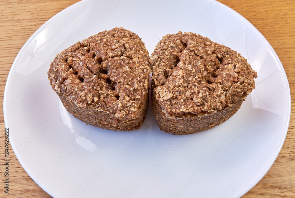 Two slices of fresh homemade bread made from wheat and rye on a white plate Two slices of fresh homemade bread made from wheat and rye on a white plate