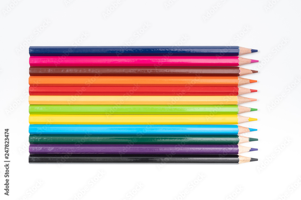 Colored pencils in a row isolated on white background. Colored pencils in a row isolated on white background.