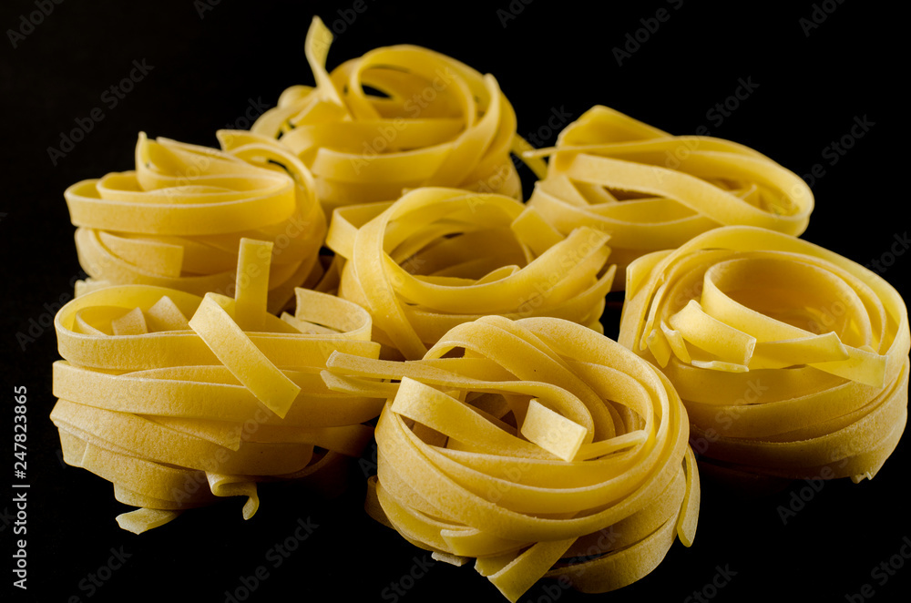 Round balls of raw pasta on black background Round balls of raw pasta on black background