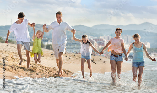 Parents children running on beach