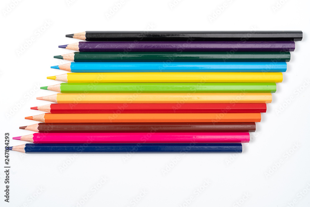 Colored pencils in a row isolated on white background. Colored pencils in a row isolated on white background.
