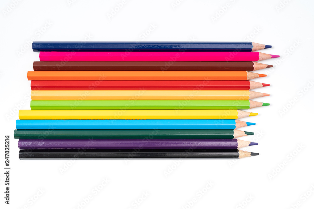 Colored pencils in a row isolated on white background. Colored pencils in a row isolated on white background.