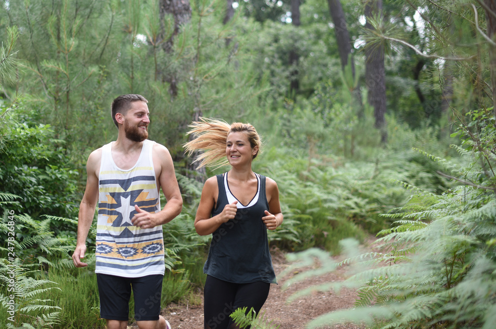 Fototapeta premium couple exercising in a wood