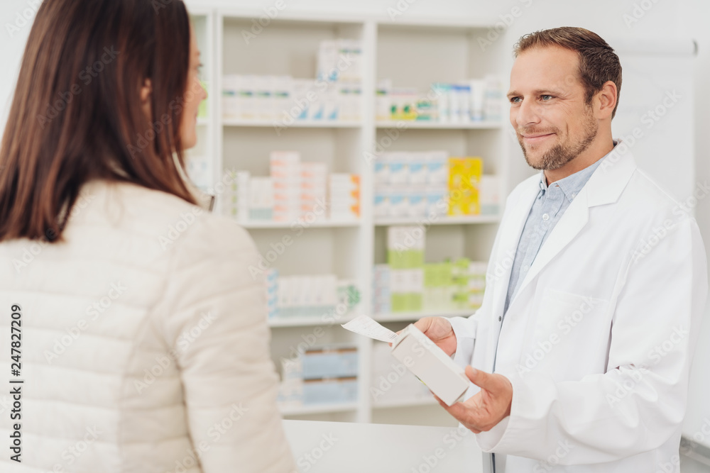 Friendly pharmacist helping a female patient