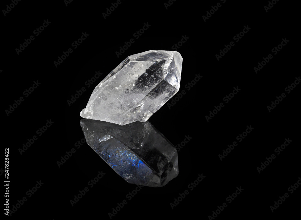 Transparent Quartz crystal with blue reflection, isolated on black background Transparent Quartz crystal with blue reflection, isolated on black background