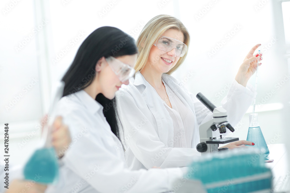 young scientists are testing the liquid in the laboratory young scientists are testing the liquid in the laboratory