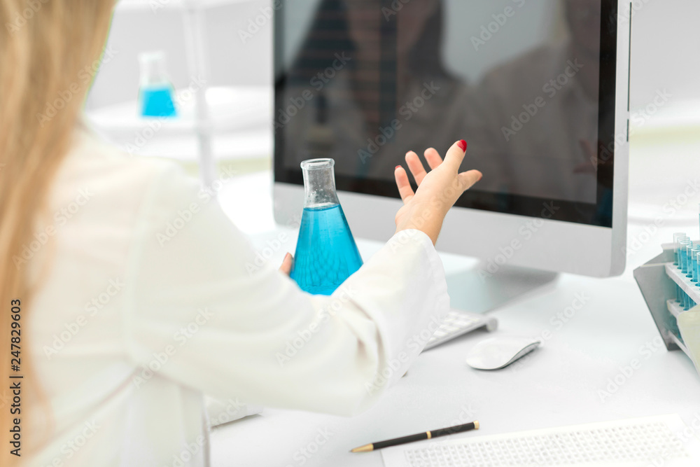 rear view.female scientist working on a computer in the lab