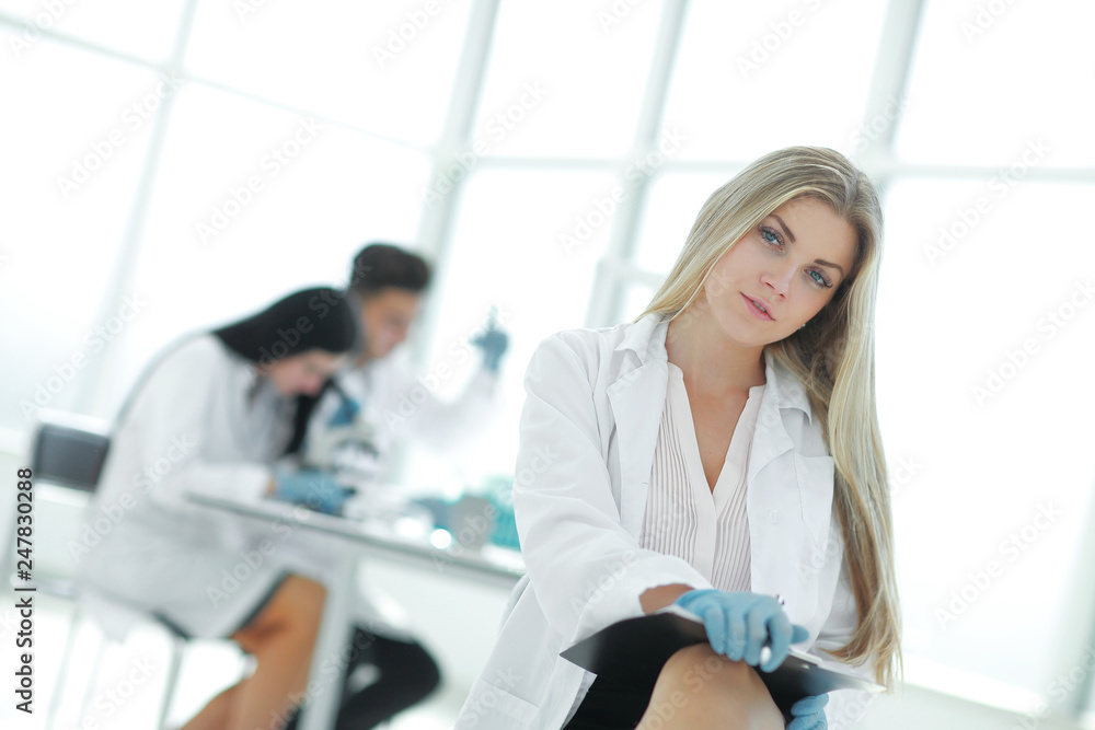 close up. female scientist taking notes on clipboard close up. female scientist taking notes on clipboard