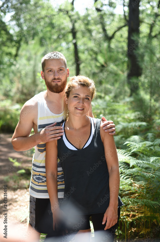 couple exercising in a wood