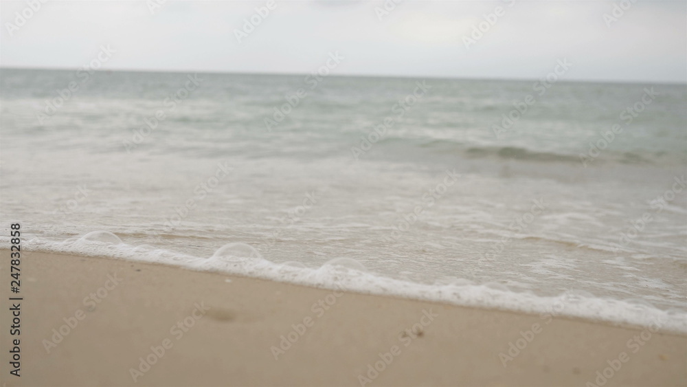 Sea waves over the sandy beach Festive background