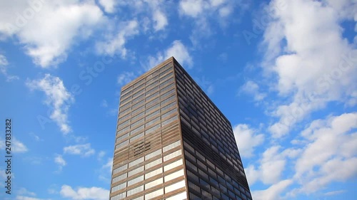 Looking up at a tall building in the clouds that could be kingpins hide out or a highly respectable Office photo