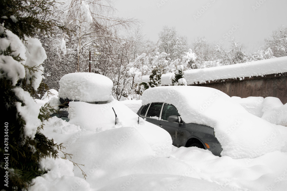 Snow covered cars in winter season, snowstorm