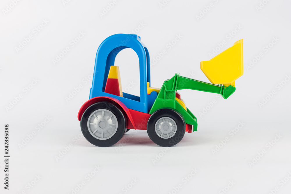 Baby toy colored tractor excavator on a white background