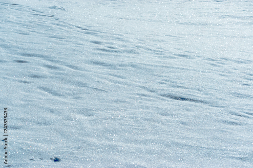 Sparkling snow. Winter atmosphere. Background of snow