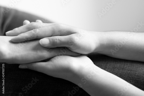 Black and white photo of hands holding together; concept of hope and encourage.