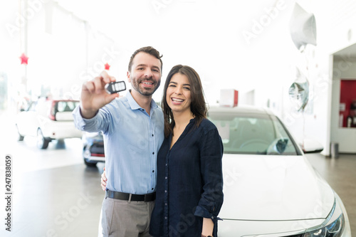 Hispanic Couple Showing Off New Car Keys With Pride