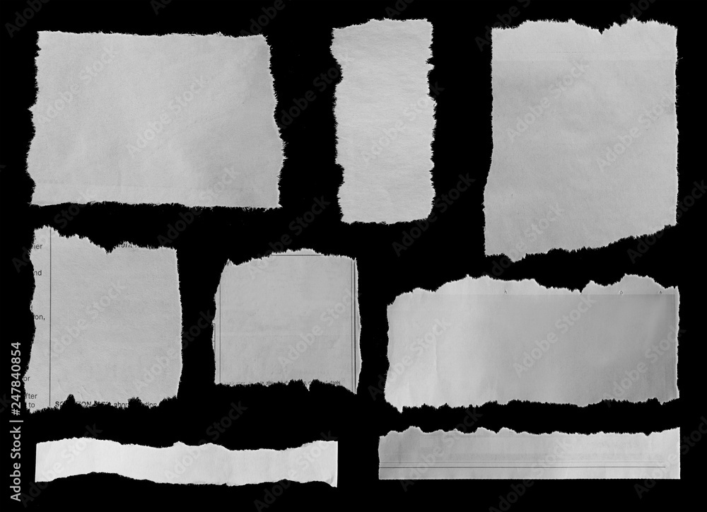 Torn white papers on black