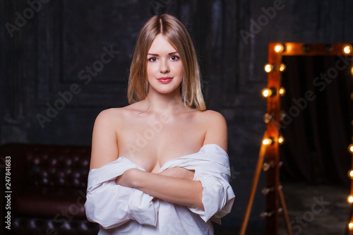Fashion shoot of young sexy woman in white shirt