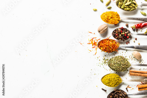 Fototapeta Naklejka Na Ścianę i Meble -  Set of various spices in spoons on white