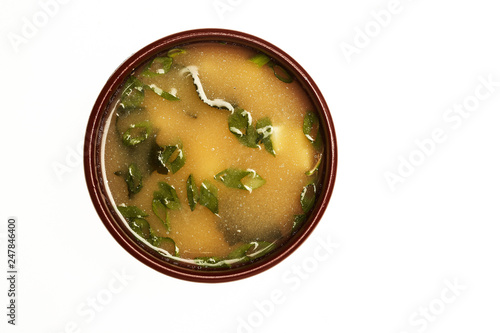 Asian soup with cod, egg and shrimps isolated on white.