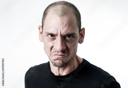 Mad and aggressive guy in facial expressions and negative human emotions photo