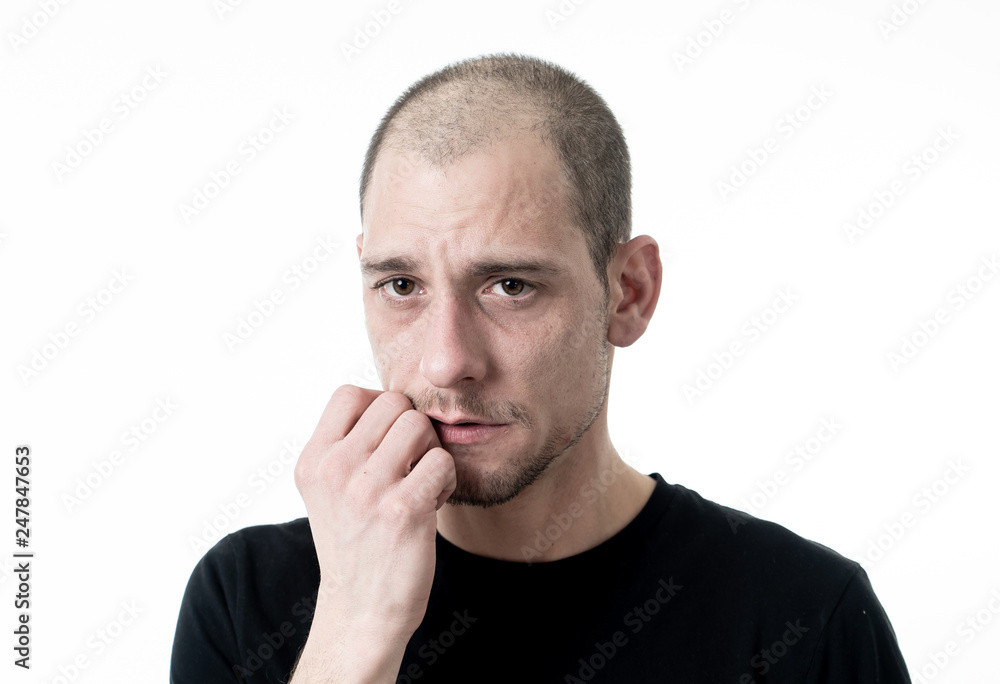 Close up portrait of sad young man face suffering from depression, stress and unhappiness.