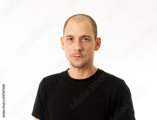Human expressions and emotions. Portrait of young attractive man with a serious neutral face