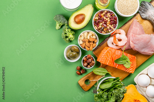 Mediterranean diet concept - meat, fish, fruits and vegetables on bright green background