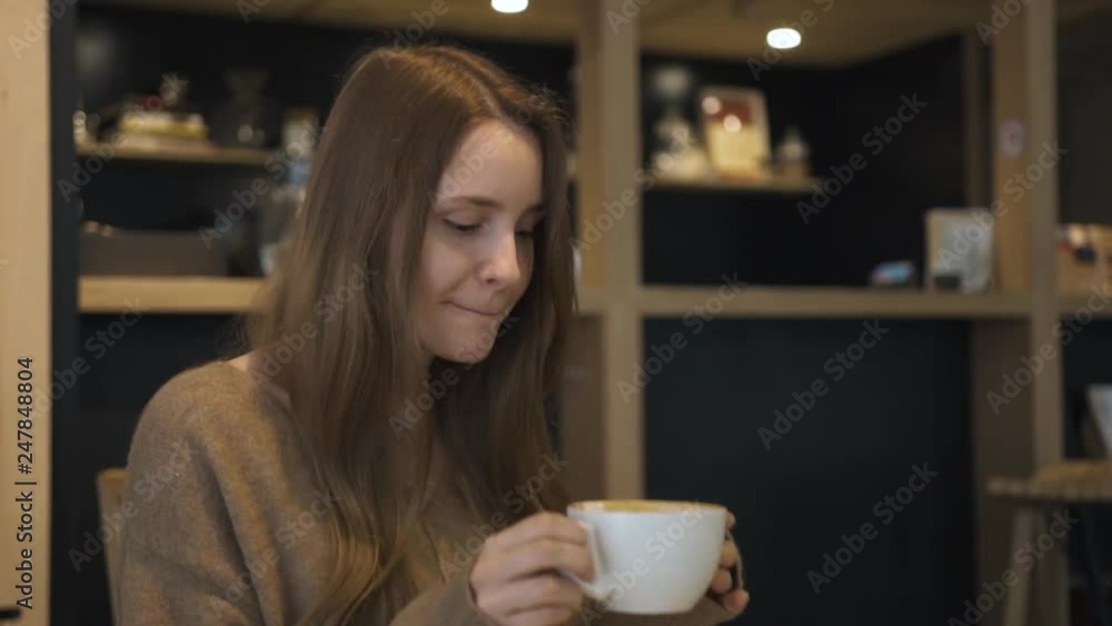 Young woman drinking morning coffee and smiling Young woman drinking morning coffee and smiling