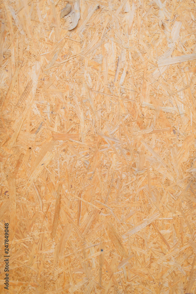 Chipboard sheet texture. The use of chipboard in construction. Treated